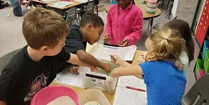An image of groups working together to build their roads using the materials.
