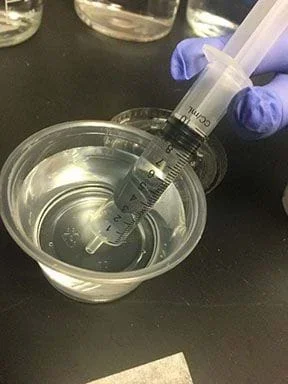 An image demonstrating how to use the plunger syringe.