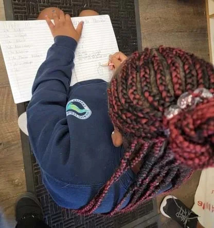 Student writing in science notebook