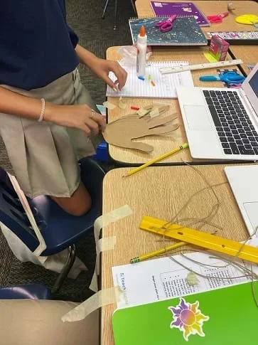 Students work at their desks to build prototypes.