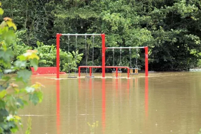 An image of a children’s playground set under several feet of water.