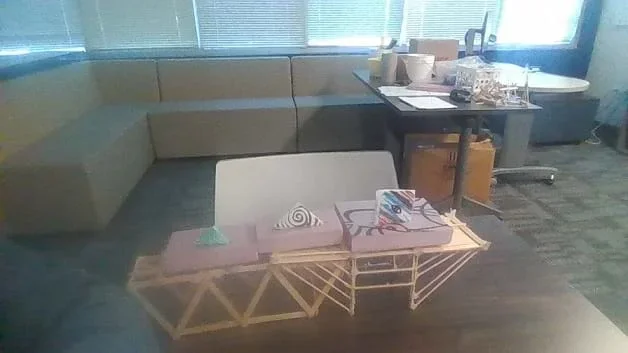 A photo showing three of the champion paper footballs sitting on display. This shows the finished project of what students are trying to build, giving them an example to strive for.