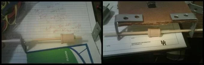Two photos: A wooden dowel (axle) is fitted through a bracket and the center of a wooden spool (drive-train). A cut-out in the cardboard piece where the motor, rubber band, and spool will be connected to make the drive-train.