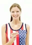 Photo shows a woman holding a burning sparkler.