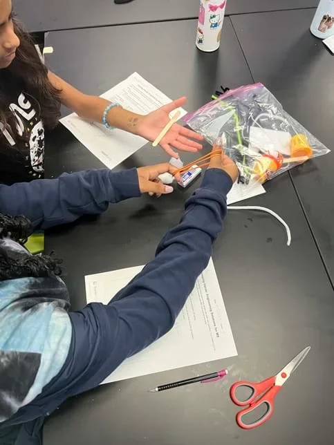 A photo showing students designing and building their device.