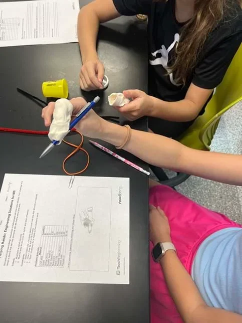 A photo showing students designing and building their device.