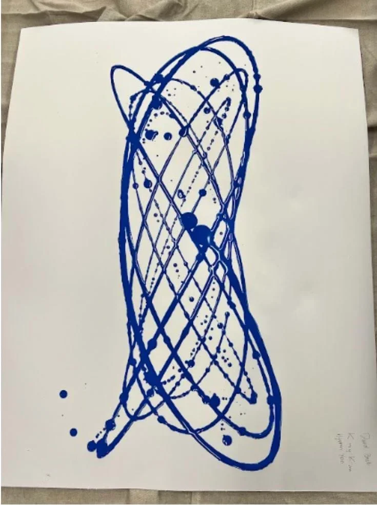 A photo showing a Lissajous pattern created by a paint pendulum.