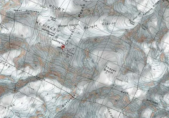 A satellite image overlaid by a topographic map of Denali, the tallest peak in Alaska. Glaciers, snow and rock cover most of the mountain, while topographic (contour) lines show elevation. The area is characterized by steep areas and large basins formed by glaciers.