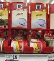 Photo shows a shelf with little jars labeled "Alum."