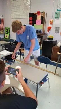 Photograph of students performing a gum stretch.