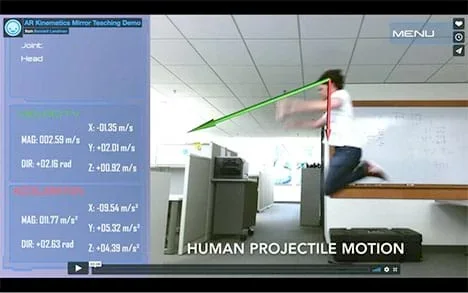 A photograph shows a student in mid-jump. A superimposed red arrow indicates the direction of his acceleration and a green arrow indicates the direction of his velocity. To the side, a numerical display lists those quantities.