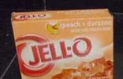 Photo shows orange box of peach-flavored JELL-O gelatin desert mix.