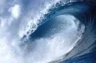 Photo shows a curving, crashing wave of blue water.