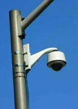 Photo shows a security camera on a street corner, another security system design.